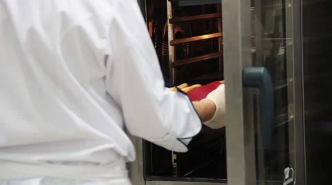 Chef pulls a tray of fried fish and puts it on the table Stock Footage 61092792