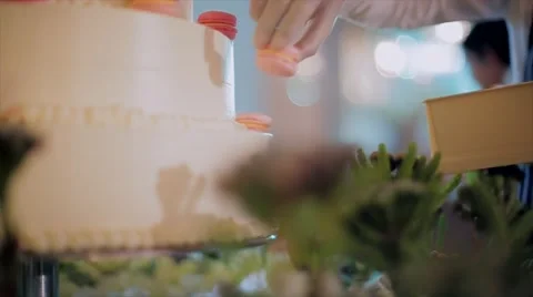 Chef push colorful macaroons on wedding cake . 動画素材 67197784