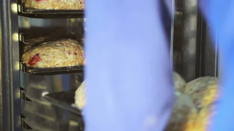 The chef pushes the bread into the oven. Preparation for baking bread with Stock Footage 118362078