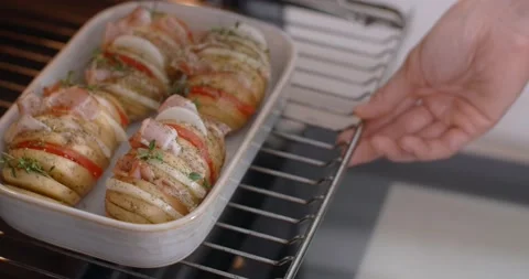 Chef pushes raw dish with potato and meat into the oven. Cooking at home, 4k 60p Video stock 167022523
