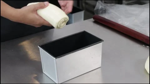 Chef put the loaf dough in the loaf pan Stock Footage 296045631