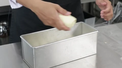 Chef put the loaf in the loaf pan Stock Footage 296045683