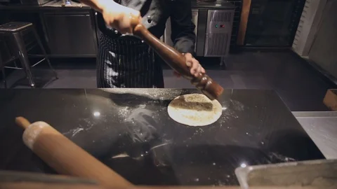 Chef put pepper and cooking pizza in hotel kitchen Stock Footage 109613907