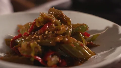 Chef put ready-made salad from edible burdock on the table Stock Footage 119189765