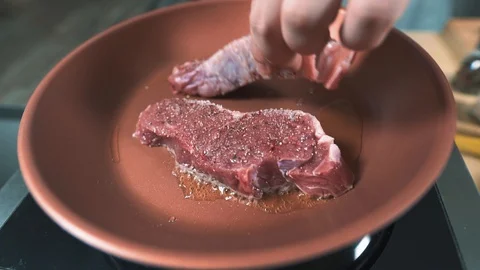 The chef put the second beef in the hot olive oil Stock Footage 128750062