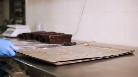 Chef puts the bakeware on a tray and takes away Vidéo 106460890