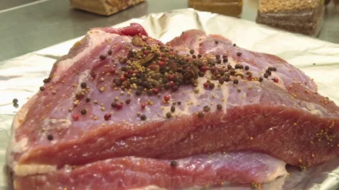 The chef puts a bay leaf on a fresh piece of pork Stock Footage 157981001