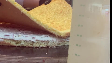 Chef puts cake base layer on white sugar curd cream and strawberry pieces Stock Footage 311422474
