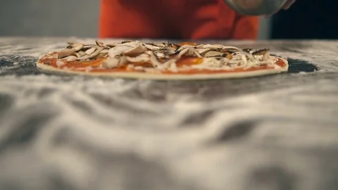 Chef puts champignons on the pizza. Slow Motion Stock Footage 74473151