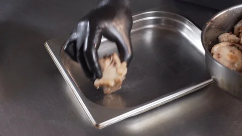 The chef puts the chicken on a baking sheet Stock Footage 127566266