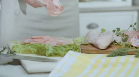 Chef puts chicken, turkey, on the kitchen table, on a wooden board with lettuce Stock Footage 68721426