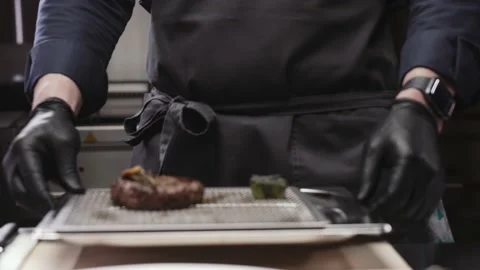 The chef puts cooked meat on the table Stock Footage 168193848