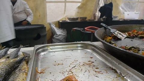 The chef puts the cooked royal prawns on a disposable plate, fast food Stock Footage 84252424
