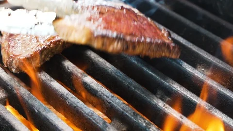 Chef puts a delicious piece of meat on the grill Stockbeeldmateriaal 108349577
