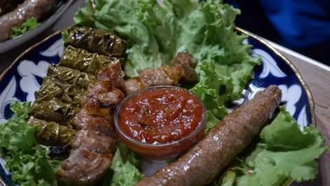 The chef puts on a dish cooked kebabs, beef ribs, sarma Stock Footage 124727772