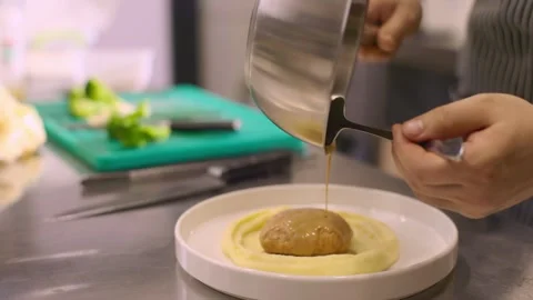 The chef puts the dish on the plate. Stock Footage 277131964