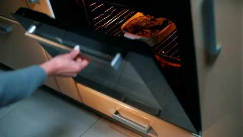 The chef puts a fish and vegetable dinner in a preheated oven Stock Footage 145435158