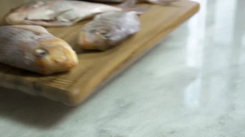 Chef Puts fresh fish on table to prepare it for cooking Stock Footage 135194072