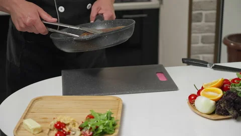 The chef puts the freshly cooked steak on a tray and drizzles it with oil to Stock Footage 154934776
