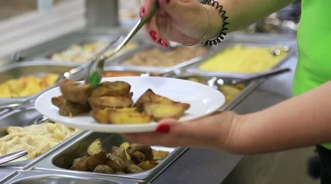 Chef puts fried potatoes on a white plate in cafe Stock Footage 65178939