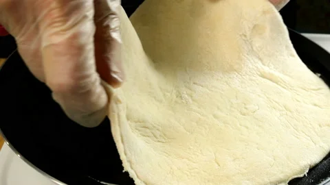 Chef puts on hot frying pan with olive oil, flatbread. Stock Footage 131439090