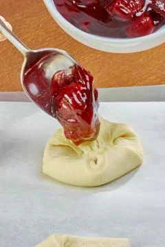 Chef puts jam on the dough cheesecakes with jam Complete Series Food recipe Stock Photos