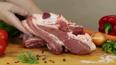 Chef puts a large piece of raw beef Stock Footage 122171269
