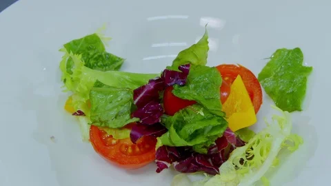 The chef puts lettuce in a bowl Stock Footage 70972901