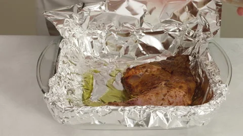 Chef puts marinated chicken meat into a prepared baking pan Stock Footage 143244138