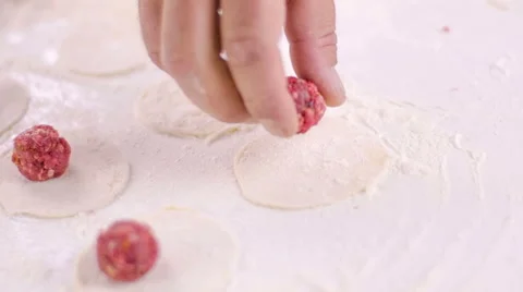 Chef puts meat ball on dough Stock Footage 49216495