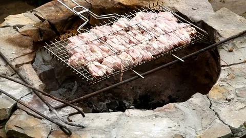 Chef puts meat on the fire, barbecue. Chef measures temperature Stock Footage 77490745