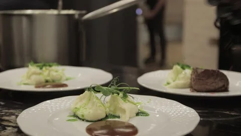 The chef puts the meat on plates with the mashed potatoes Stock Footage 300028222