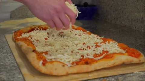 Chef puts the mozzarella on a big pizza Stock Footage 85007506
