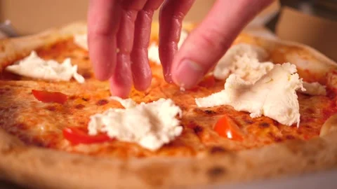 Chef puts a mozzarella pieces on a pizza cooking in restaurant kitchen Stock Footage 158999916