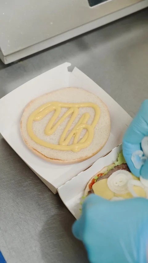 The chef puts onion stuffing in a burger Stock Footage 171412524