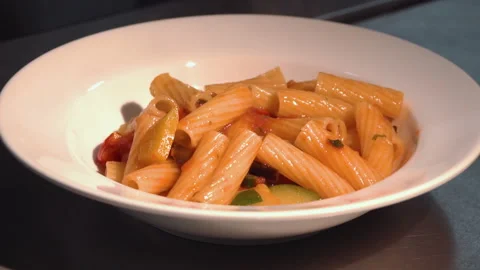 The chef puts pasta with vegetables on a plate Stock Footage 158020583