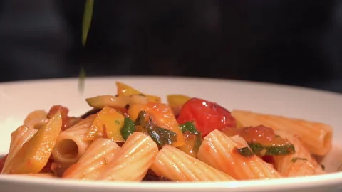 The chef puts pasta with vegetables on a plate Stock Footage 158020592