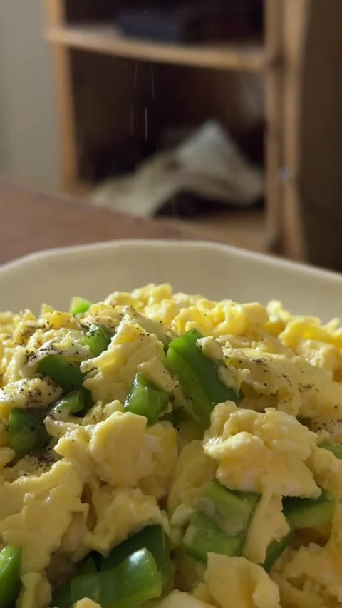 A chef puts pepper on creamy scrambled eggs on toasted bread with fresh salad Stock Footage 340541621