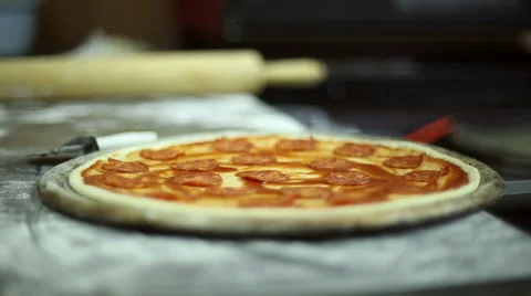 The chef puts the pieces of ham on dough Stock Footage 59699561
