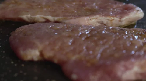 Chef puts pieces of meat in a pan Stock Footage 67764901