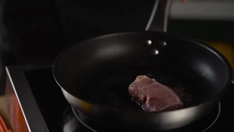 The chef puts the pieces of meat in the pan. Stock Footage 248161694
