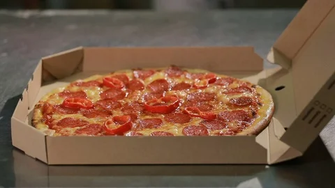Chef puts the pizza inside a pizza box. Ready for delivery Stock Footage 73254521