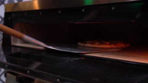 The chef puts pizza in the oven Stock Footage 135312661