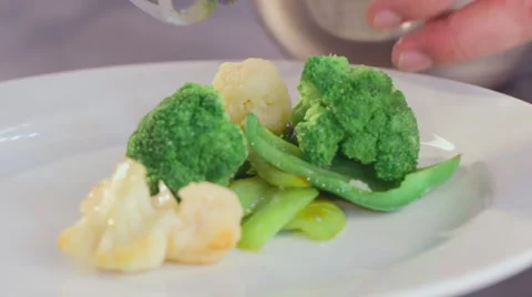 The chef puts on a plate of cauliflower and broccoli Stock Footage 55628601