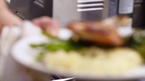 Chef puts plate with food on table and cleans Stock Footage 127600980