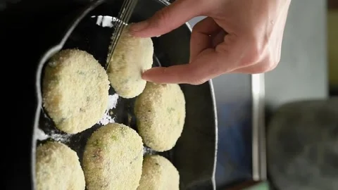 The chef puts potato and bacon patties in the pan. Stock Footage 305154708