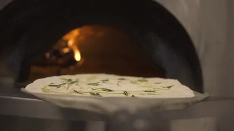 Chef puts Quattro Formaggi on a pizza peel to burning oven in restaurant kitchen Vídeo Stock 218861793