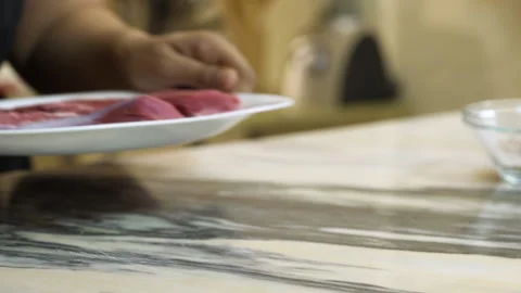 Chef puts raw beef steak on the kitchen table Stock Footage 135476370