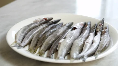 Chef puts raw fresh fish on table Stock Footage 122337076