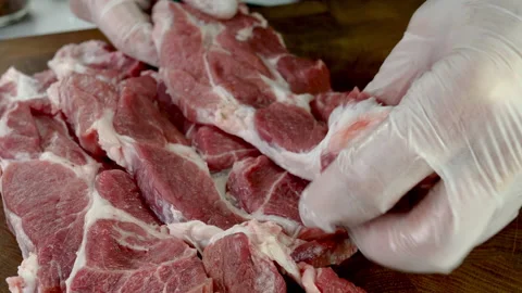Chef puts raw meat steaks on cutting board and sprinkles with spices. Stock Footage 234066536